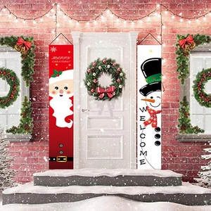 Christmas door banners featuring Santa and Snowman hanging on a festive white front door