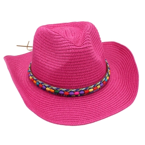 Detail of fuchsia woven straw cowboy hat with vibrant multi-color beaded ethnic band