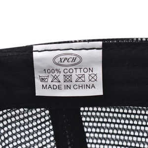 Detailed macro view of internal 100% cotton wash label on the black mesh cap