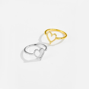 Detailed macro of S925 sterling silver heart rings with paved white cubic zirconia