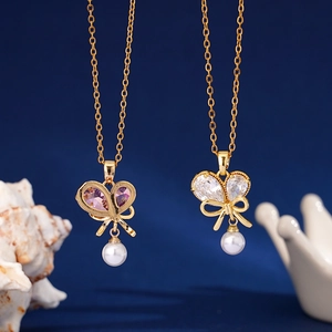 Elegant gold butterfly necklaces with pearls and purple zircon on a deep blue background