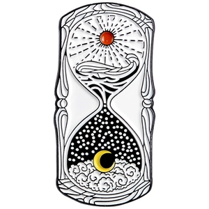 Detailed close-up of a metal enamel hourglass pin featuring sun and moon artistic motifs