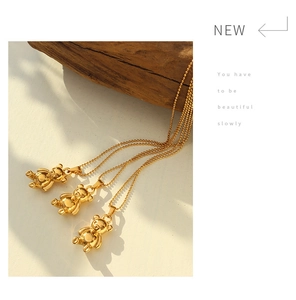 Detailed close-up of 18K gold-plated 3D bear pendants on elegant bead chains