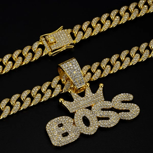 Close-up of golden BOSS crown pendant and iced out Cuban link chain with crystals