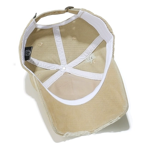 Internal view of khaki distressed canvas baseball cap with adjustable metal buckle strap