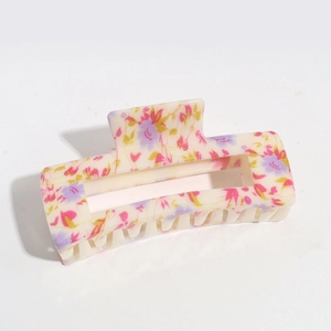 Detailed view of floral hollow hair claw clip with pink and purple ink flower patterns