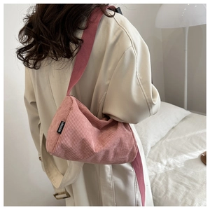 Close-up detail of pink corduroy tote bag showing soft ribbed texture and fabric strap