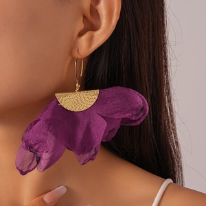Macro view of purple chiffon flower earrings with golden hammered metal texture details