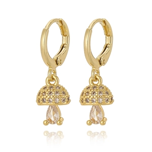 Close-up of gold mushroom earrings with zircon inlay and pear-shaped stones on white