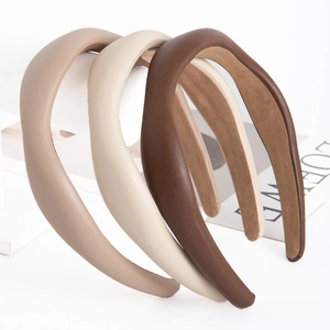 Detailed view of three vintage PU leather headbands in brown, coffee and beige colors