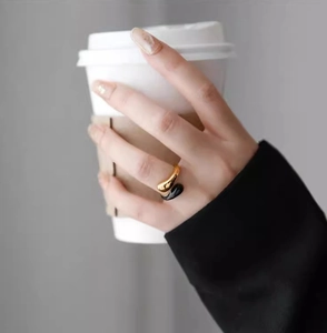 Minimalist teardrop open ring in 18K gold and black enamel, worn on model finger