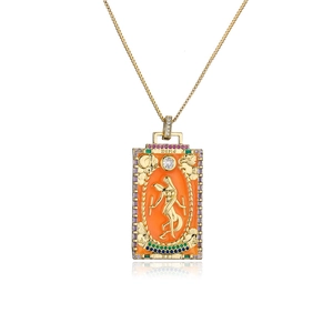 Macro detail of 18K gold tarot pendant with orange enamel and colorful crystals