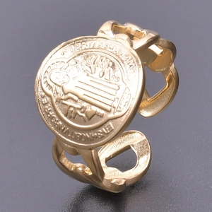 Detailed view of golden Saint Benedict Medal ring with hollow adjustable band