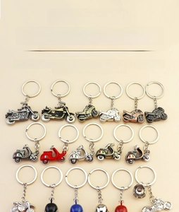 Detailed view of zinc alloy motorcycle keychains with helmets in various metallic finishes
