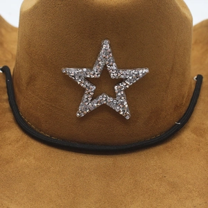 Detail of brown suede cowboy hat featuring silver rhinestone star patterns and braided cord