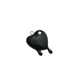 Minimalist black melting heart pendant with golden ring on white background