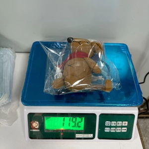 Detailed weight check of a Christmas plush mouse toy on a digital scale showing 119.2g