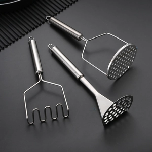 Three professional stainless steel potato mashers with different heads on a dark surface