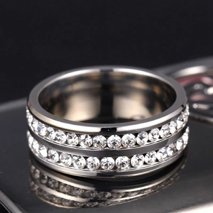 Macro view of double-row pavé set cubic zirconia on a polished silver stainless steel ring