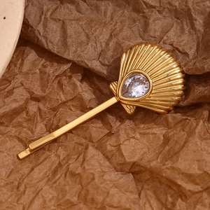 Macro shot of 18K gold plated shell hair clip with sparkling pear-cut zircon stone