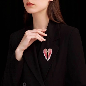 Pink gradient angel wing brooch with crystals on a black suit jacket lapel