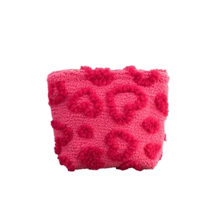 Fuzzy pink heart makeup bag made of soft plush fabric for travel storage