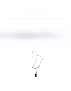 Detail view of drop necklace with pink zircon and blue water drop pendant in copper