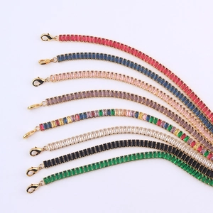 Detail of colorful rectangular zircon tennis bracelets with gold-plated lobster clasps