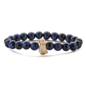 Detail shot of navy tiger eye beads bracelet with a white penguin charm on white background