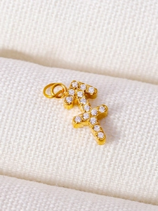 Detailed close-up of a Sagittarius constellation charm with gold plating and zircons