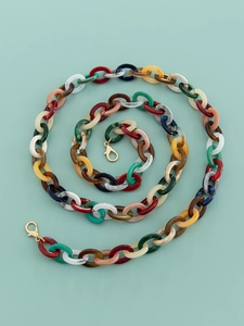 Close-up of colorful acrylic chunky bag chains with gold clasps in spiral layout