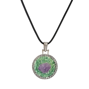 Macro shot of geometric purple amethyst necklace with green chips and sparkling crystals