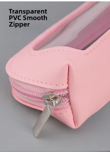 Close-up of pink leather cosmetic bag featuring a clear PVC window and smooth silver zipper