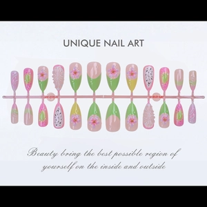 Detail of almond press-on nails with 3D floral carvings and dragon fruit patterns