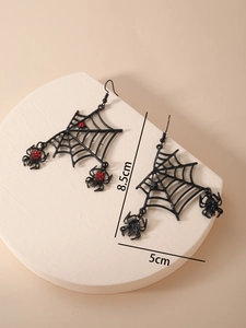 Detail showing red rhinestones on black spider web earrings with 8.5cm measurement