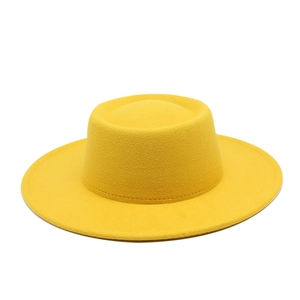 Close-up of a bright yellow wool boater hat showing fine stitching and smooth felt texture