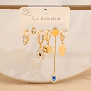 Macro view of a 6-piece golden stainless steel earring set with evil eye and hamsa charms