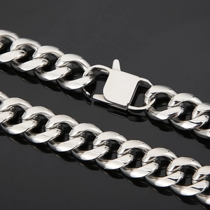 Close-up of a silver stainless steel chunky Cuban chain with a secure square clasp