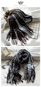 Detail of coffee blue checkered scarf featuring tassels and soft cashmere-like texture