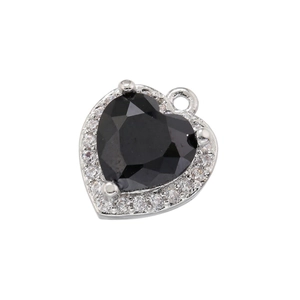 Macro view of a black heart zircon pendant with clear stones in a silver setting