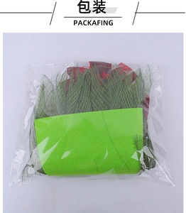 Detailed view of DIY Christmas wreath kit materials including green mesh and red ribbon