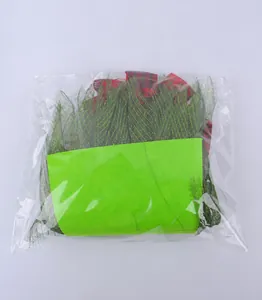 Detailed view of DIY Christmas wreath kit materials including green mesh and red ribbon