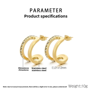 Detailed view of gold C-shaped earrings with double-layer spiral and white rhinestones