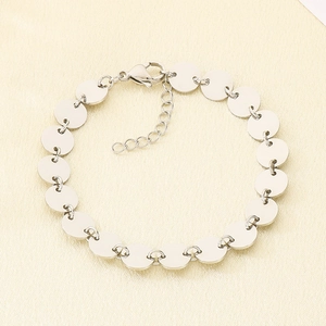Detailed view of the silver disc bracelet featuring a lobster clasp and extension chain