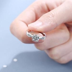 Classic four-prong round zircon open ring with polished silver finish on finger