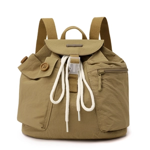 Detailed view of durable nylon backpack with drawstring closure and pocket buckles