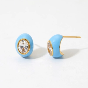 Detailed view of blue enamel oval stud earrings with faceted zircon and gold plating