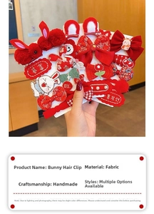Detailed handmade rabbit hair clip with red fabric bow and festive embroidery