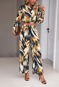 Detailed view of women's two-piece set with yellow and blue abstract patterns