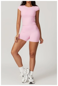 Pink high-stretch yoga set with tight short-sleeve top and high-waist shorts for women
